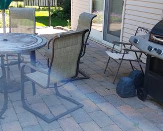 patio table and chairs, gas grill