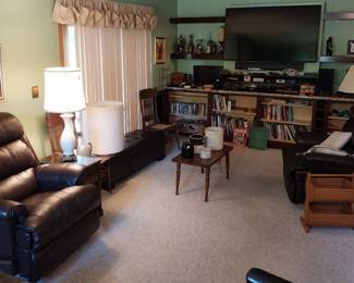 La Z Boy leather swivel rocker recliners, storage bench, Atari w/paddles, joystick, and games, Sony blu-ray player, Sony component system, Sony soundbar, Sony Bravia 65” TV, Bose soundlink mini, Canon EOS 630, iHome dock radio, Amazon echo dot