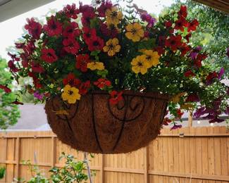 A pair of colorful hanging flower baskets
