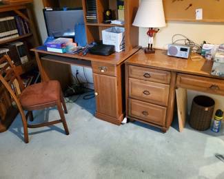 The right desk is solid wood knee-hole desk.