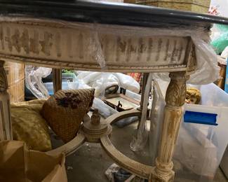 the distressed table skirt legs and threshold of this beautiful black marble top table