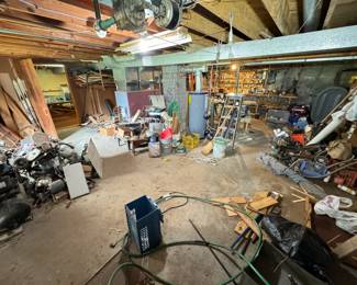 Large workshop full of tools, wood, scrap metal, odds & ends