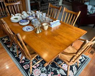 Colonial-style dining table with eight chairs and pads.
