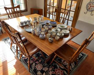 Another look at colonial-style dining table with eight chairs and pads.