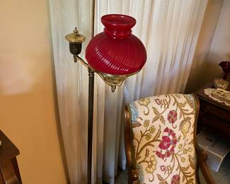 Vintage brass floor lamp with red glass shade.