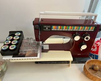 Husqvarna Viking 6000 SL sewing machine with manuals, case, and many accessories.