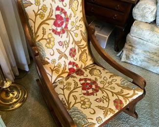 Vintage rocking chair with floral upholstery.