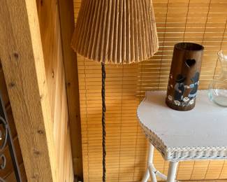 Vintage floor lamp with ornate metal base.