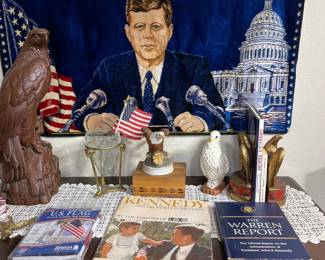 Notice the tapestry of President Kennedy. Sitting on the vintage chest are items about President Kennedy. The vintage chest measures 40"w x 20"d x 35"h. 