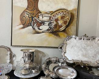 Above the silver is a large piece of art titled "Broken Pottery" by Natonichee.