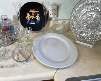 Just to the left of the glass platters is an antique hen on a nest candy dish.