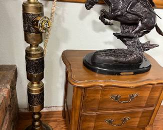 Notice the 42-inch-tall brass telephone. To the right of the phone sitting on the 2-drawer bedside chest is a bronze Rembrandt style sculpture of an Indian on a horse.