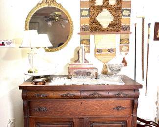 This amazing buffet is 48" wide and 23"deep.  it has 3 drawers and 2 cabinets. Did you notice the antique round mirror? The modern tapestry pairs well with the buffet.