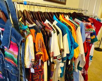 Approximately sixteen tops, shirts, and blouses with mola trim. Size medium and large.