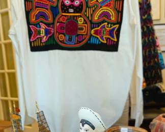 An entire mola is a bold accent on the back of this unisex shirt. Montuno figure 