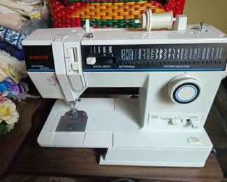 Singer sewing machine in a floor style cabinet is like new.