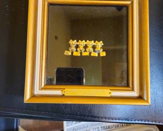 One of two framed huacas of golden frogs.