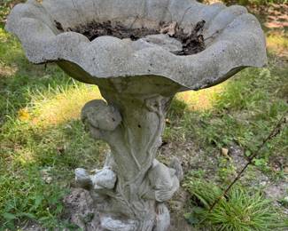 Concrete squirrel bird bath