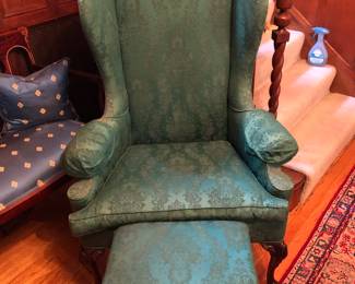 One of a pair of green wing back chairs