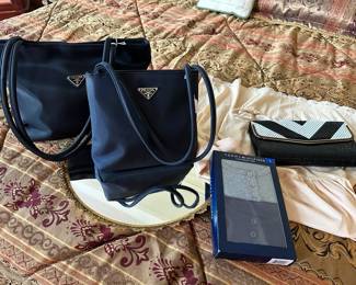 Mirrored tray, Prada bags, Platform bed frame with drawers, Comforter, Decorative pillow
