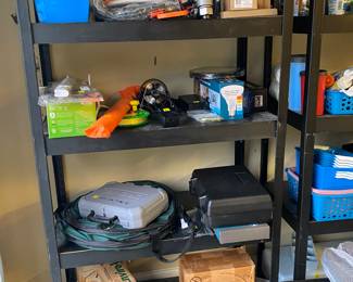 Metal racks loaded with camping supplies and everything else. 