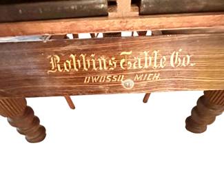 A fine antique dining table by Robbins Table Co. Has a unique storage space that contains the table’s 6 leaves!