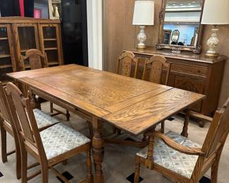 Antique oak table with 6 chairs.  Both ends fold under