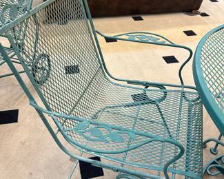 Wrought iron patio set - 4 spring loaded rocker chairs - table - and umbrella stand included.