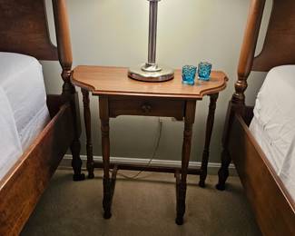 Small wooden table with silver based table top lamp 