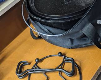 Lodge cast iron Dutch oven with cover and fire hooks.