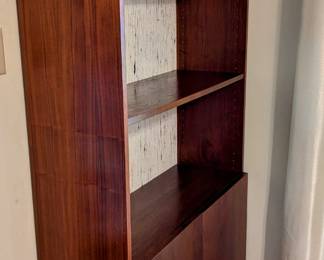 $60 - Bookcase with wallpapered backing and two-door cabinet. There are 2 available.