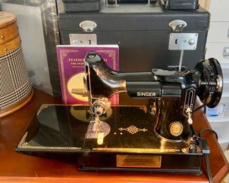 Singer Featherweight 221 with case, accessories and manual.