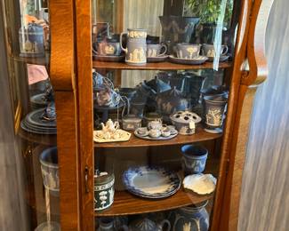 5'4" china cabinet filled with Wedgewood
