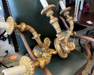 Giilded candelabras and great accent chair in green leather. 