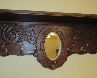 Antique hat/coat rack with beveled mirror.