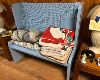 Blue bench, quilts and blankets