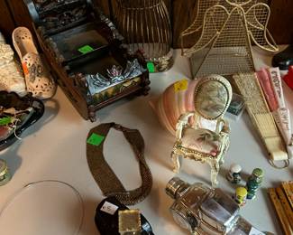 Full Avon cologne bottles, costume jewelry, and home decor