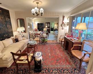 Stunning sitting room!  Antique Chinoiserie four-panel screen, antique Oriental rug, vintage elephant cocktail table, pair of carved French caned armchairs, antique desk with secret kneehole compartment