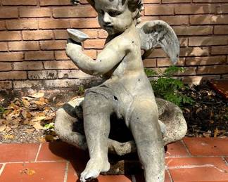 Lead cherub on cement bird bath