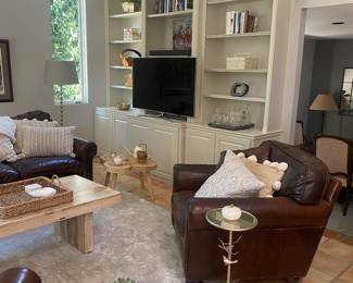 Restoration hardware 2 leather chairs with leather pillows. Also wood coffee table and 2 round tables 