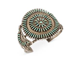 388
A Zuni Turquoise And Silver Cuff Bracelet
Mid/late 20th century
Unmarked
A three-wire cuff with cluster-set needlepoint turquoise
6.25" inner C x 2" H with a 1" gap
43.3 grams gross
Estimate: $300 - $500