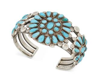 391
A Southwest Silver And Turquoise Cuff Bracelet
Early 20th century
Unmarked
A three-wire silver cuff with three cluster-set turquoise plaques and stamped terminals
7" inner C x 1.75" H, with a 1.125" gap
74.1 grams gross
Estimate: $500 - $700