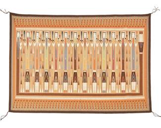 214
Etta Peacock (B. 20th Century, Diné)
A Navajo Yei textile
Woven in brown, tan, grey, rust, orange, cream, yellow, black, and blue wool, depicting twelve Yei dancers and a rainbow guardian, with a complex sawtooth border
47.5" H X 64.75" W
Estimate: $4,000 - $6,000