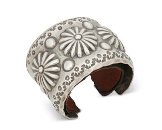 403
An Emerson Bill Navajo Sterling Silver Cuff Bracelet
Emerson Bill (b. 20th century, Diné)
Stamped: Emerson [script] / Sterling
A wide chunky cuff with elaborate stamped and repoussé medallion motifs, with a leather liner
7" inner C x 2.125" H, with a 1.375" gap
103.1 grams
Estimate: $400 - $600