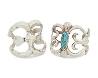 397
Two Cast Silver Cuff Bracelets
Late 20th century
One marked with an etched arrow cipher
Comprising two chunky openwork cast silver cuffs, one with central oval bezel set turquoise, 2 pieces
Larger: 7" inner C x 2.5" H, with a 1" gap; smaller: 6.75" inner C x 2.375" H, with a 1.125" gap
144.7 grams gross
Estimate: $700 - $900