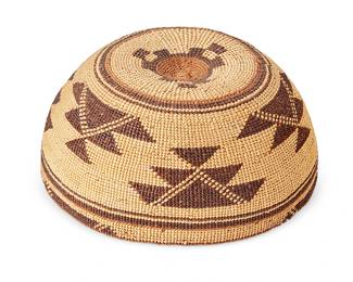 115
A Hupa/Yurok/Karuk Polychrome Basketry Hat
Early 20th century; Northern California
The twined hat with imbricated brown and orange banded stripe and geometric motifs
3.25" H x 7" Dia.
Estimate: $700 - $900