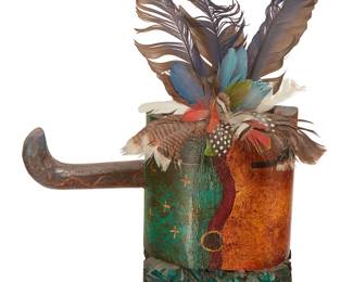 308
Gregory Lomayesva (B. 1971, Hopi-Tewa)
A Hopi Shalako-style day/night katsina mask, 1995
Signed and dated verso: Gregory Lomayesva / 95
The polychrome carved wood mask with mounted feathers, one side of the face representing day, the other representing night
Overall: 26.5" H x 13.5" W x 6" D; Wood: 9" H x 13.5" W x 3.25" D
Estimate: $300 - $500