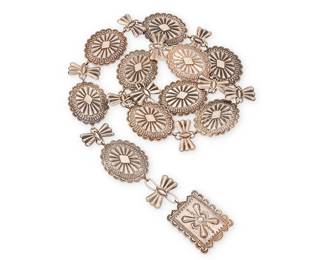 442
A Southwest Silver Linked Concho Belt
Mid-20th century
Unmarked [Old Pawn etching to buckle]
A link belt with finely stamped and repoussé conchos, alternating oval and butterfly forms and with a rectangular buckle
35.5" L x 1.75" H
176.6 grams gross
Estimate: $500 - $700