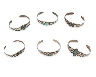 412
A Group Of Fred Harvey Silver And Turquoise Cuff Bracelets
Early/mid-20th century
Three marked for sterling; one further stamped: Maisels / Albuquerque
Six narrow ornate silver and set turquoise cuffs, all in various styles and sizes, with motifs including stampwork, thunderbirds, arrowheads, and crossed arrows, 6 pieces
Largest: 6.5" inner C x 0.5" H, with a 1" gap; smallest: 5.75" inner C x 0.5" H, with a 0.875" gap
77.8 grams gross
Estimate: $700 - $900