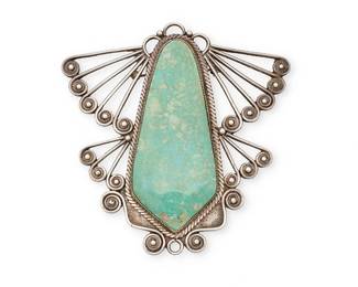 458
An Early Navajo Silver And Turquoise Brooch
Early 20th century
Unmarked
The openwork wire-formed moth motif centering a large bezel-set turquoise domed slab
4.125" H x 4.125" W
93.4 grams gross
Estimate: $600 - $800